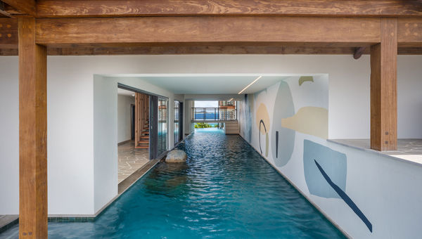 A canal-style pool weaves through indoor and outdoor areas of Moskito Island’s Cape Stout estate.