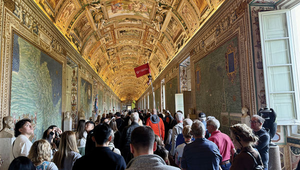 A crowd packs the Vatican Gallery of Maps at the Vatican Museum.