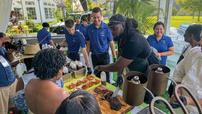 Chef and restaurateur Brian Jupiter serves smoked ribs during The Family Reunion's welcome reception.