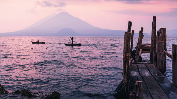 Sunset over the hills of Lake Atitlan in Guatemala, a destination considered a dupe of Italy’s Lake Como by Intrepid Travel, which offers guided tours in the region.