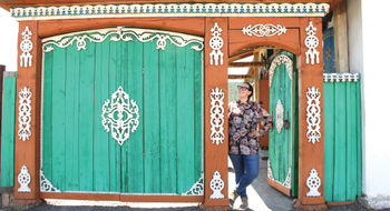 A traveler stands in a colorful doorway in Ulaanbaatar, the capital city of Mongolia, where the adventure travel company is launching a new rail itinerary in 2025.