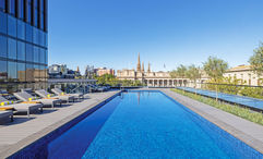 Le Meridien Melbourne's heated pool and deck is popular throughout the day. At night, the lights from the surrounding skyscrapers add to the magic