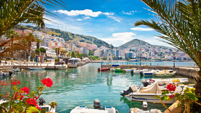 Travelers are opting for less expensive Europe destinations such as Albania. Pictured, the Albanian port city Saranda.